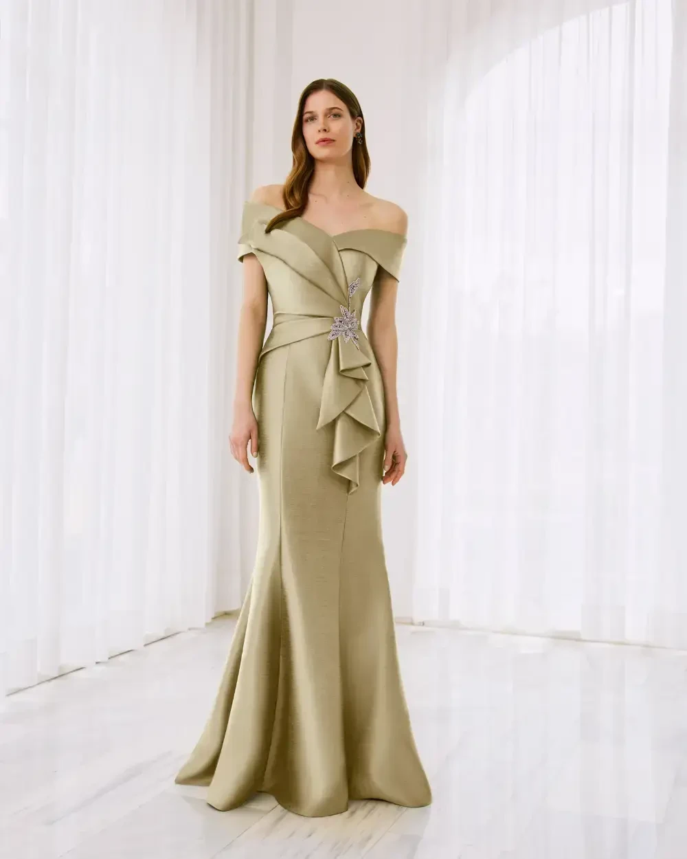 model is wearing an off the shoulder floor length mothers dress