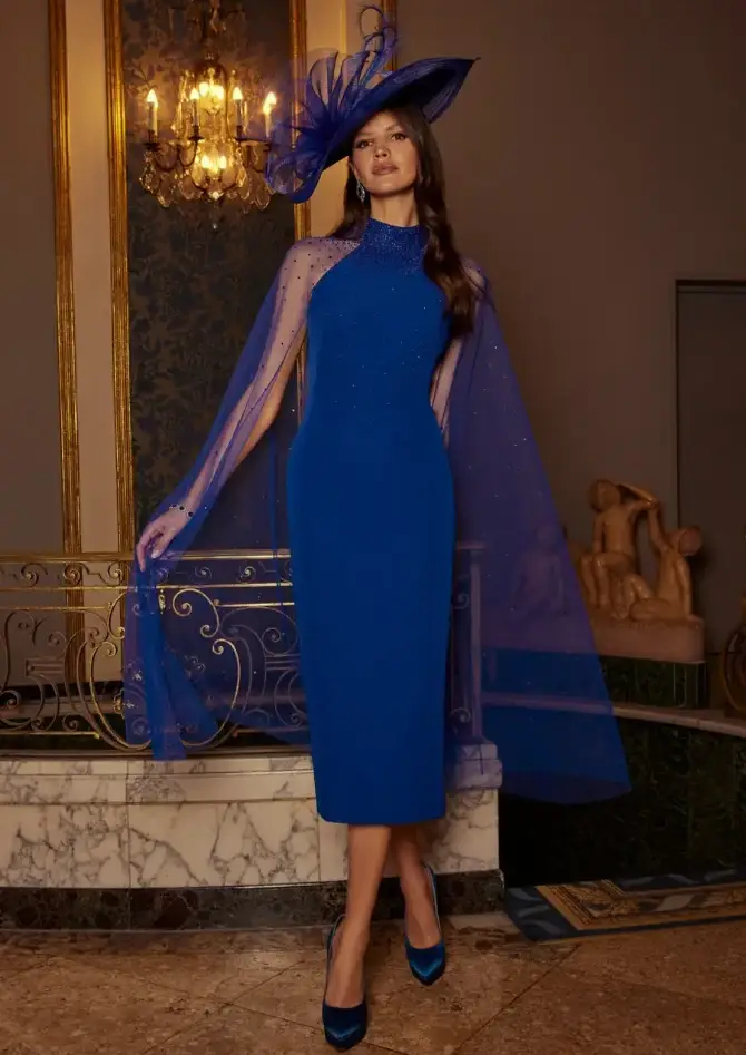 model is wearing a navy blue knee length mother of the bride dress
